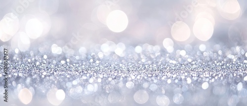 Abstract background of glittering vintage lights in silver and white, de-focused for elegant and festive banner design