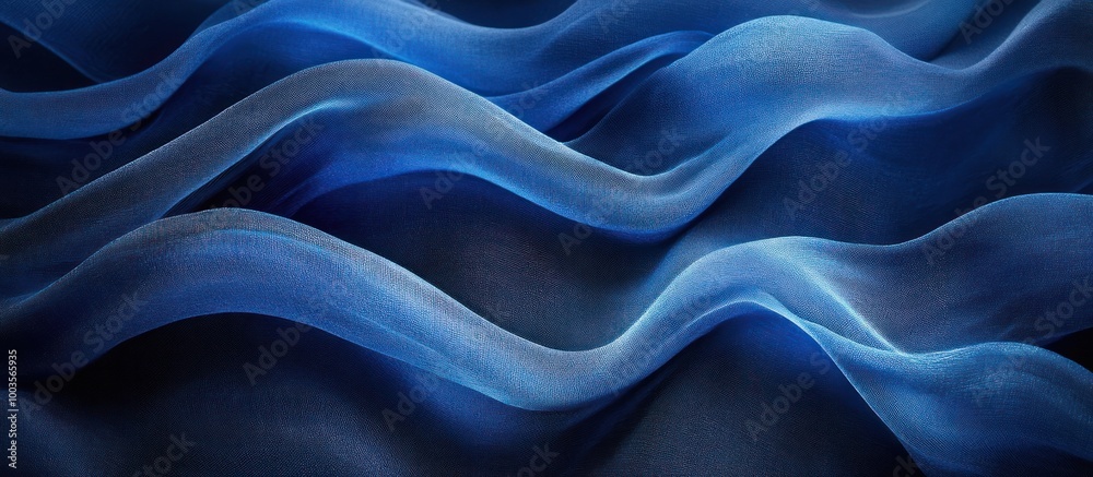 Obraz premium Abstract blue fabric texture with soft wavy lines and folds, creating a luxurious and elegant background.