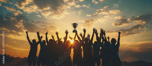 Silhouettes of a Team Holding a Trophy at Sunset