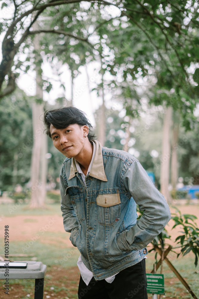 Southeast Asian man striking a pose, showcasing confidence and style. Southeast Asian man striking a pose, showcasing confidence and style.