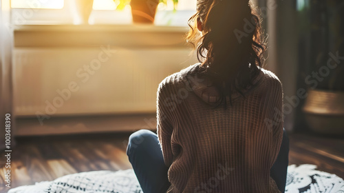 A woman listens intently during a group therapy session at a substance abuse rehabilitation program.