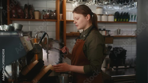 Woman barista making coffee in the cafe