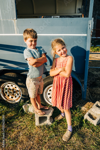 Two children smiling and posing with crossed arms photo