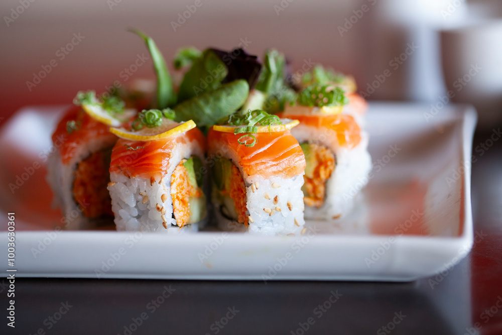 Sushi roll neatly plated with garnish Sushi roll neatly plated with garnish
