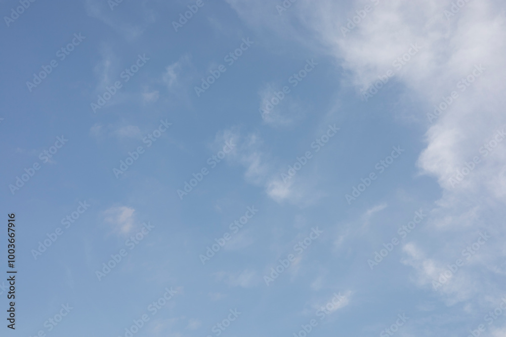 Obraz premium The clear blue sky with white clouds provides a bright and sunny background, enhancing the natural beauty of the landscape on this pleasant summer day