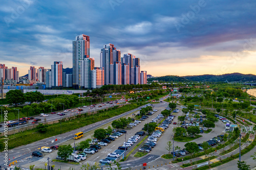 Banpo, Seocho-gu, Seoul, South Korea - May 20, 2020: Sunset view of parking lot of Hangang Citizen Park and Olympic Boulevard Expressway with highrise apartments photo