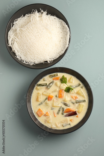 idiyappam, also known as indiappa, noolputtu, noolappam, santhagai, or ottu shavige, is a string hopper dish originating from southern india. it consists of rice flour pressed into noodles, laid into  photo