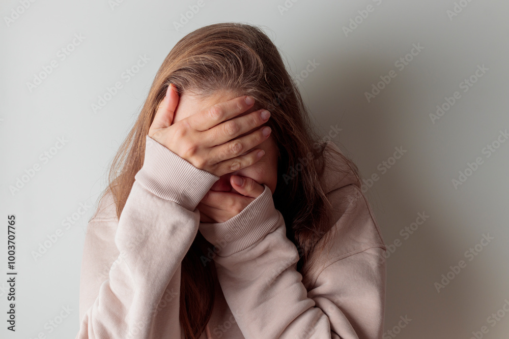 Close up unhappy young woman hiding face in hands, feeling desperate cheated hopeless alone indoors. Upset millennial girl crying, suffering from consequences of wrong decision, depression concept. Close up unhappy young woman hiding face in hands, feeling desperate cheated hopeless alone indoors. Upset millennial girl crying, suffering from consequences of wrong decision, depression concept.