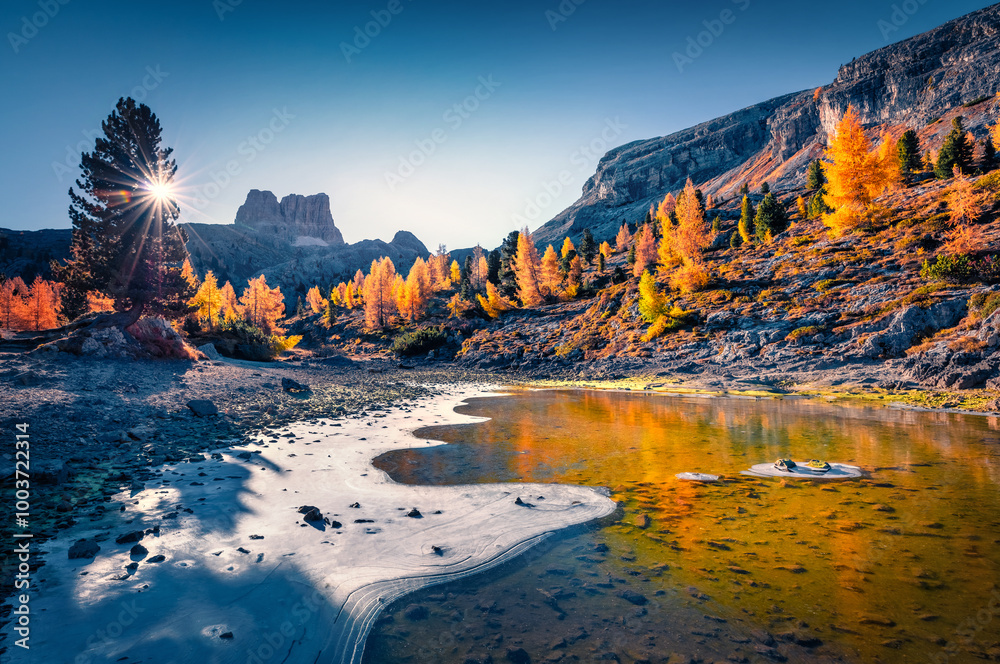 Cold morning landscape of frozen Limides lake. Wonderful autumn view of Dolomite Alps. Amazing outdoor scene of Falzarego pass, Italy, Europe. Beauty of nature concept background.