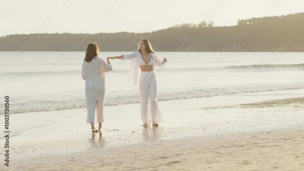 Romantic Lesbian Couple Enjoying a Sunset on the Beach Romantic Lesbian Couple Enjoying a Sunset on the Beach
