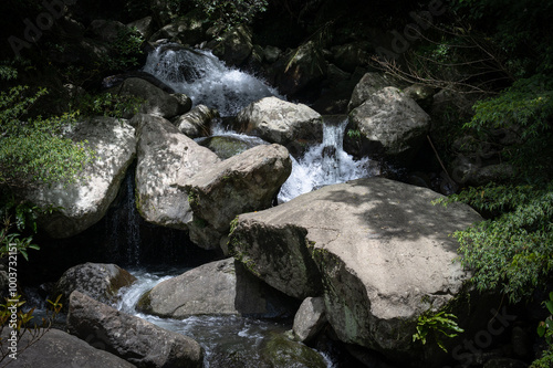 river go through many giant rocks like small waterfall, hidden in the forest, in Manyueyuan forest recreation area, New Taipei City, Taiwan. photo