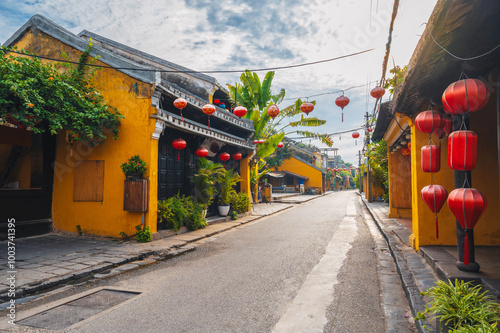 streets with traditional ancient yellow houses and buildings in the old town in Hoi An city in Vietnam photo