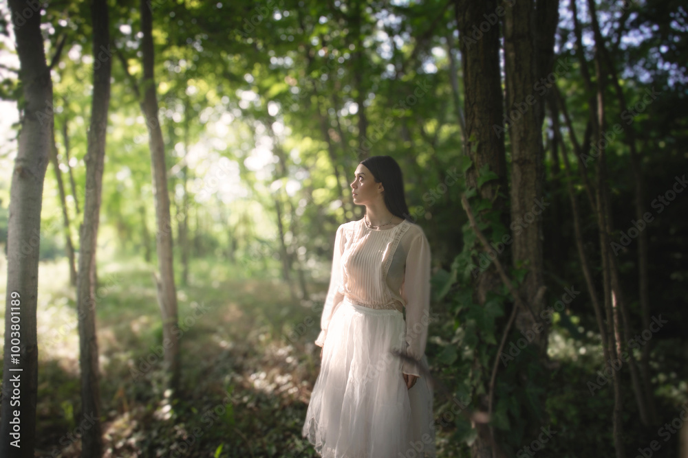 woman in the middle of nature illuminated by a ray of sun, life concept woman in the middle of nature illuminated by a ray of sun, life concept