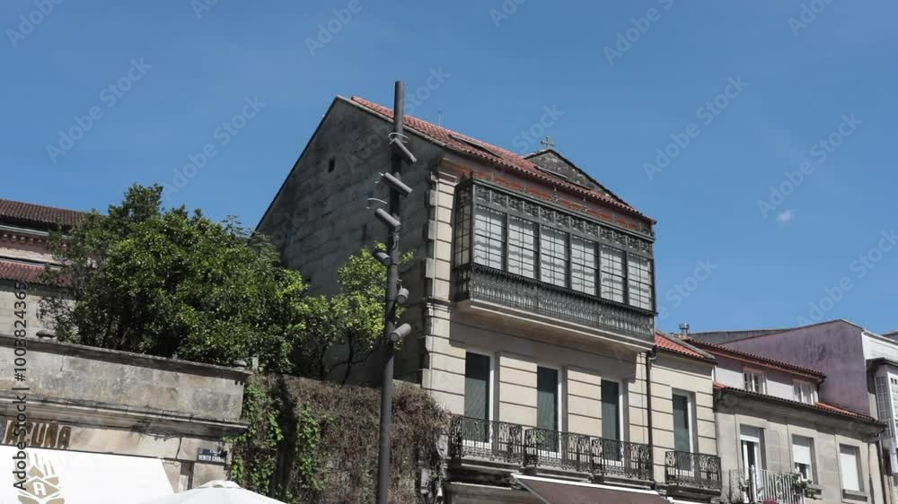 Historic building in Pontevedra, Spain, with greenery and clear blue skies captured during the day Historic building in Pontevedra, Spain, with greenery and clear blue skies captured during the day