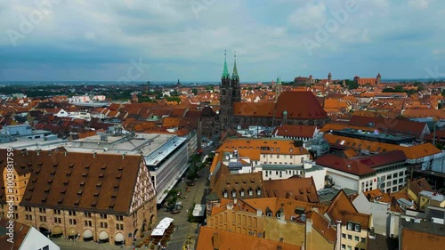 4K Aerial Drone Video of Copper-clad Spiers and Tiled Roof of St. Lawrence Church in Downtown Nurnberg, Germany photo