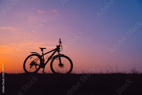 Bicycle, sunset horizon, with copy space. world bicycle day background concept. Road bike parked on a beautiful road sunset, warm light with copy space