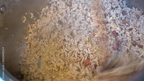 Close-up Homecooking. Making Homemade Bolognese sauce. Making Tomato Sauce. Sauteed mire poix. Cooking Tomatoes. Browning ground beef. photo