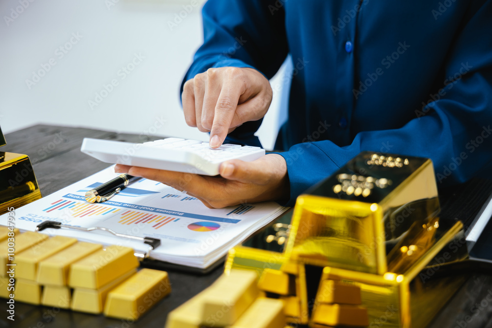 Portrait of a beautiful young businesswoman holding gold bar at office desk Portrait of a beautiful young businesswoman holding gold bar at office desk