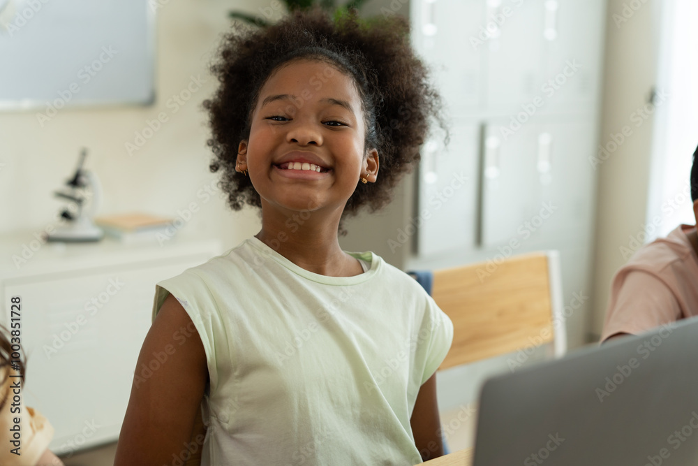 Smiling African American Girl Showing Gesture in Classroom Smiling African American Girl Showing Gesture in Classroom