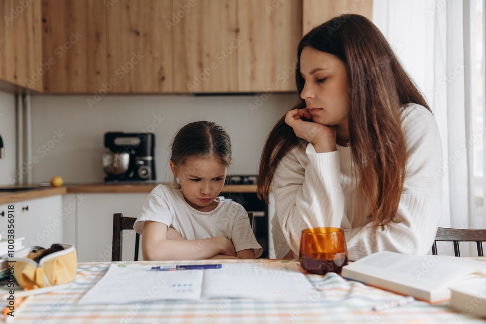 A mother helping her young daughter with homework in a cozy home setting, both smiling and enjoying the learning process. A mother helping her young daughter with homework in a cozy home setting, both smiling and enjoying the learning process.