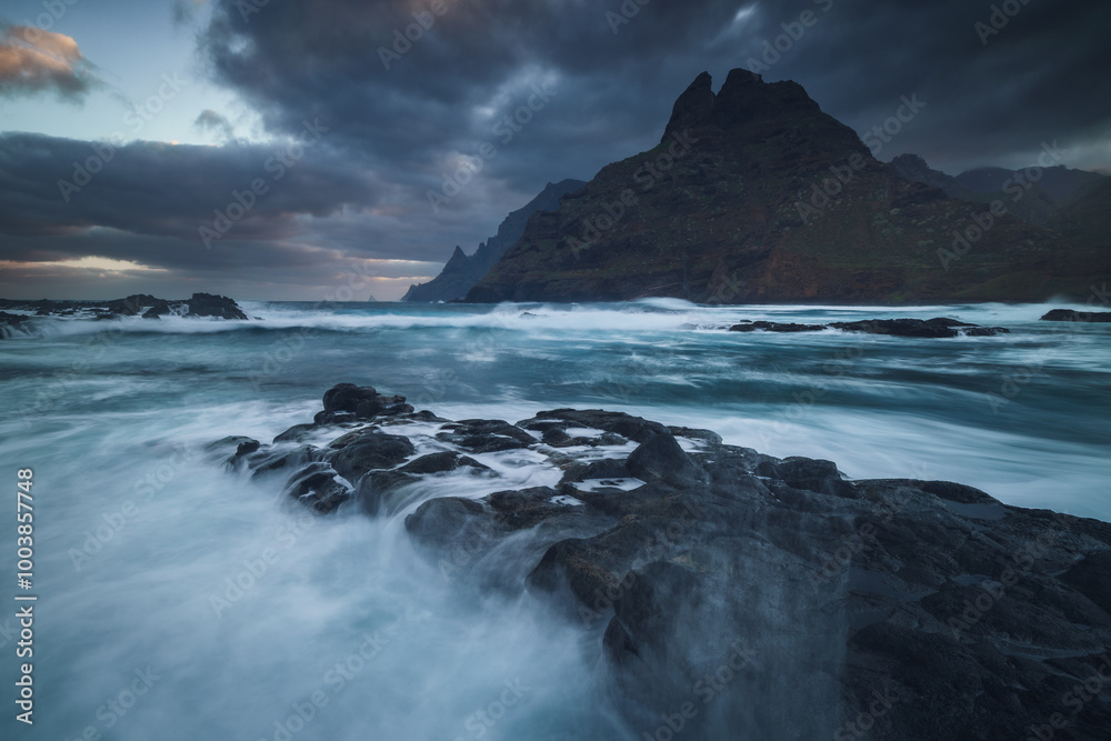 Rocky coastline in Punta del Hidalgo in Tenerife- taken on long exposure time. Dramatic sky add a mood to this picture.
