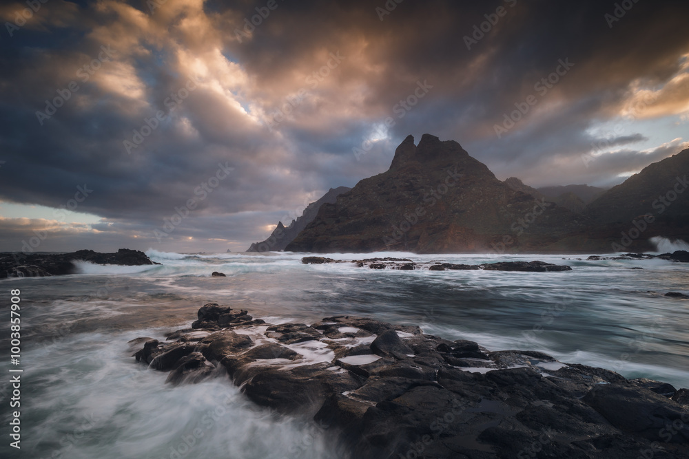 Rocky coastline in Punta del Hidalgo in Tenerife- taken on long exposure time. Dramatic sky add a mood to this picture.