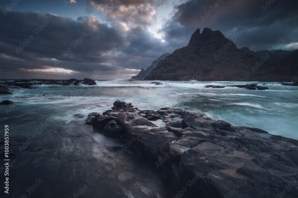 Rocky coastline in Punta del Hidalgo in Tenerife- taken on long exposure time. Dramatic sky add a mood to this picture.