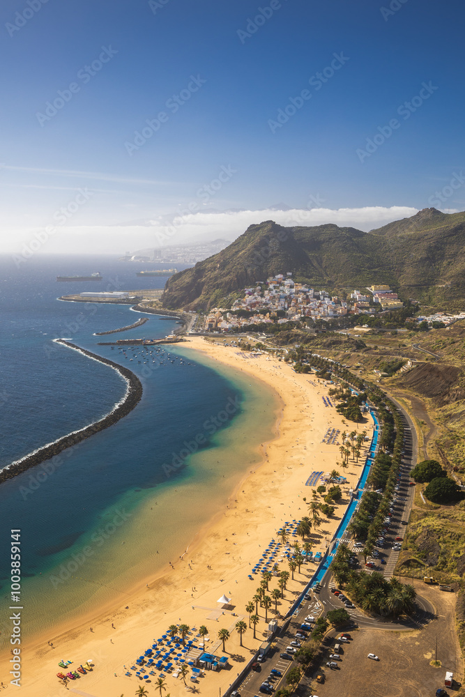 Playa de Las Teresitas captured on a warm sunny day, with the Teide volcano visible in the background.