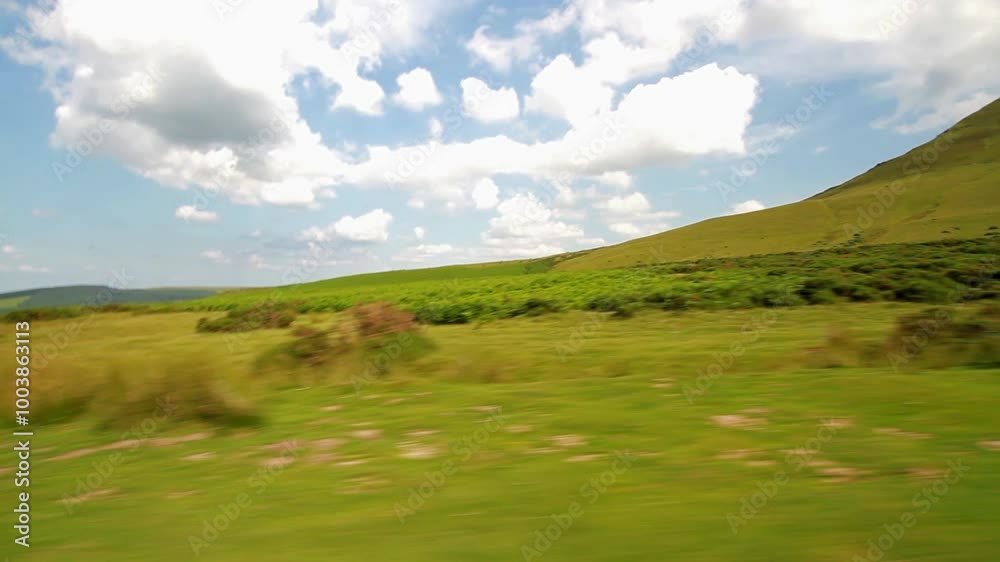 Video pan of a UK plateau grassy hill from a car looking west into Wales.. Hay bluff, Penybegwn in welsh, in the Black Mountains, South Wales, United Kingdom near the English border Video pan of a UK plateau grassy hill from a car looking west into Wales.. Hay bluff, Penybegwn in welsh, in the Black Mountains, South Wales, United Kingdom near the English border