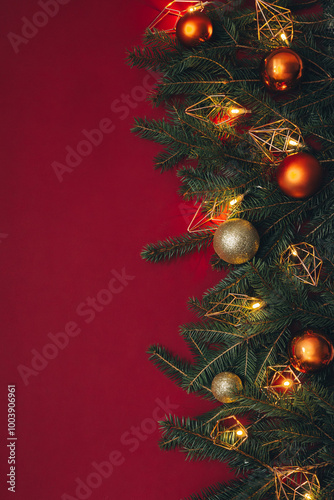 Christmas background with Christmas lights and fir toys. Red background.