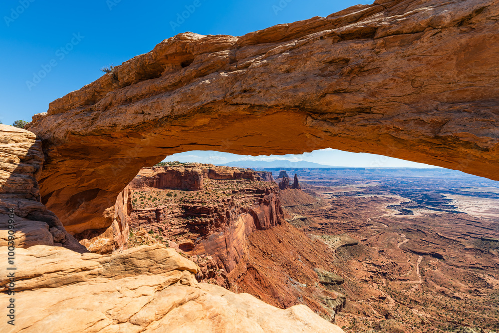 The most famous landmark of the Island in the Sky District of Canyonlands national park in Utah USA - The Mesa Arch in a blue day.