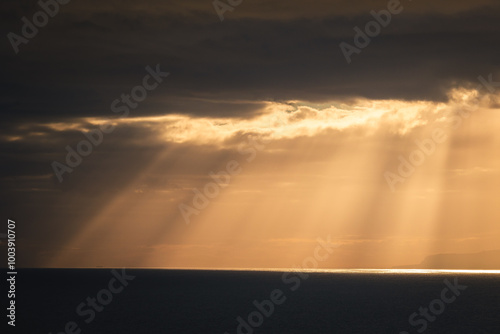 Obraz na płótnie The sun's rays break through the clouds and create a beautiful atmosphere - the island of La Gomera in the background. w salonie