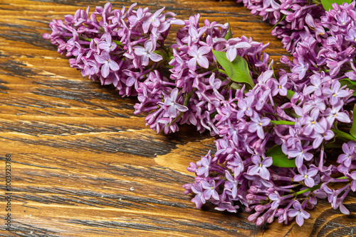 Beautiful spring flowers lilac on a wooden vintage board with place for text. Syringa vulgaris. Happy Mother's Day greetings card.