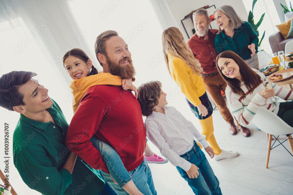 Obraz premium Photo of friendly sweet family play spend time together have fun piggyback eating holiday dinner smiling hugging indoors house room