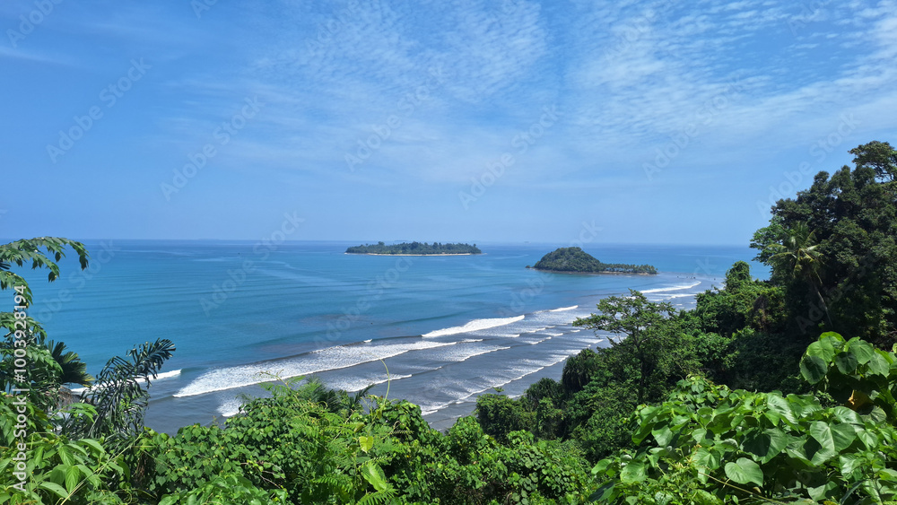 Beautiful views of hills and islands. The blue sky is slightly cloudy. Picture taken from the top of the hill. Padang, West Sumatra, Indonesia. Beautiful views of hills and islands. The blue sky is slightly cloudy. Picture taken from the top of the hill. Padang, West Sumatra, Indonesia.