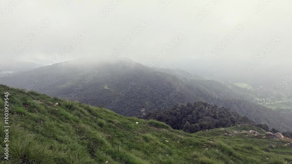 Mist-covered valley view from a high altitude, showcasing the serene beauty of fog rolling over the mountains and valleys, with breathtaking views of the landscape below Mist-covered valley view from a high altitude, showcasing the serene beauty of fog rolling over the mountains and valleys, with breathtaking views of the landscape below
