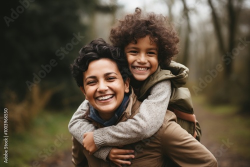 South asian mother and son smile laughing hugging.