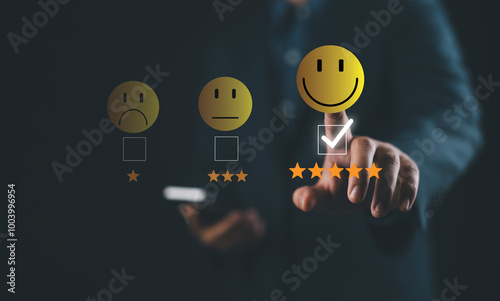 Foto Businessman using smartphone and pushing smile button for the best evaluation , customer satisfaction concept