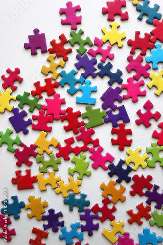 Colorful jigsaw puzzle pieces on white background. Flat lay.