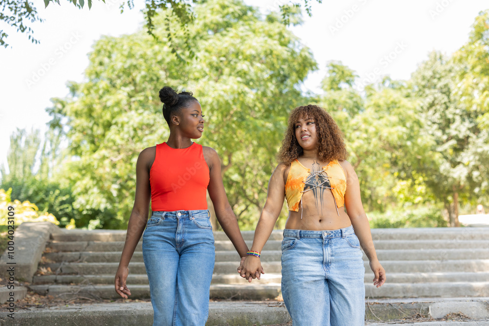 Diverse LGBTQIA+ couple enjoying a walk in the park Diverse LGBTQIA+ couple enjoying a walk in the park