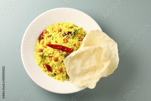 Lemon Rice or fodnicha bhat is South Indian turmeric rice or maharashtrian recipe using rice garnished with nuts curry leaves and lemon juice photo