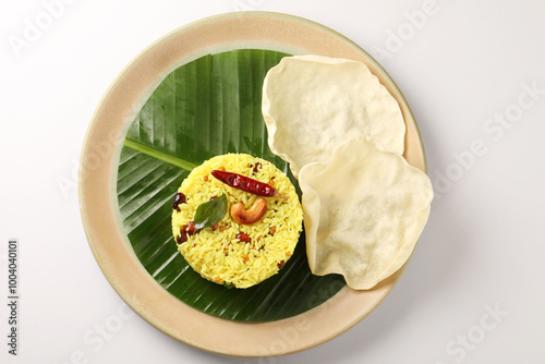 Lemon Rice or fodnicha bhat is South Indian turmeric rice or maharashtrian recipe using rice garnished with nuts curry leaves and lemon juice photo