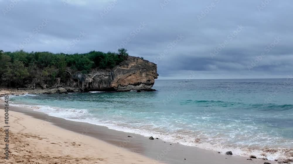 Cliff at the Shipwreck Beach on Kauai, known for surfing and sunset viewing popular spot for cliff jumping, at sunset. Beach at Grand Hyatt Kauai Resort Spa Cliff at the Shipwreck Beach on Kauai, known for surfing and sunset viewing popular spot for cliff jumping, at sunset. Beach at Grand Hyatt Kauai Resort Spa