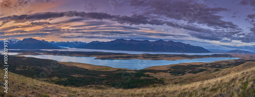 Panoramic photo of Cerro Cristal and Lago Roca in Patagonia, Argentina, captured at sunset with a dramatic purple sky.