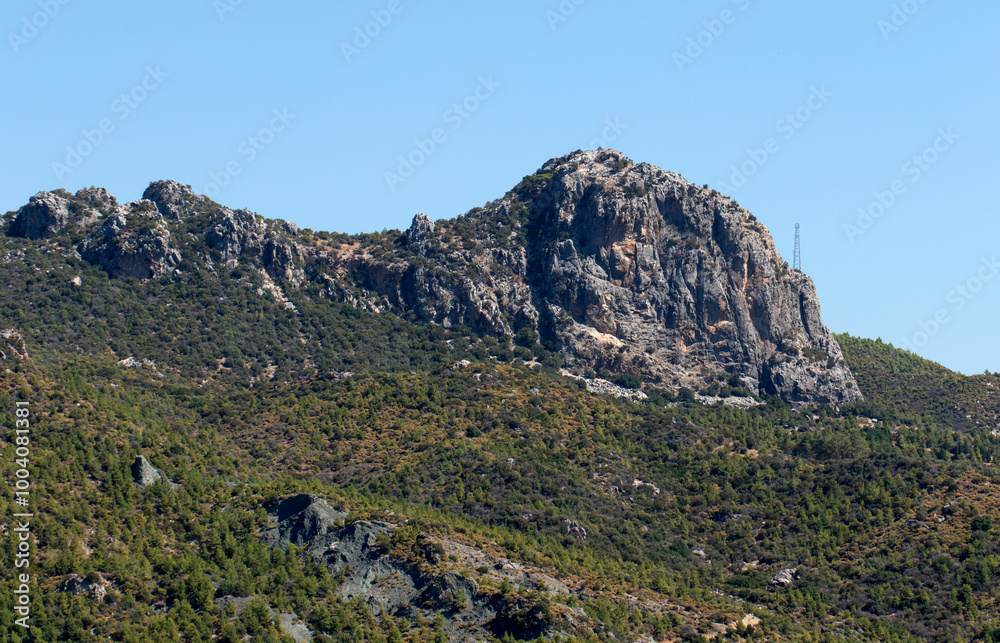 A view of the cliffs and maquis covered hills near the ancient city of Aspendos in the Serik district of Antalya A view of the cliffs and maquis covered hills near the ancient city of Aspendos in the Serik district of Antalya