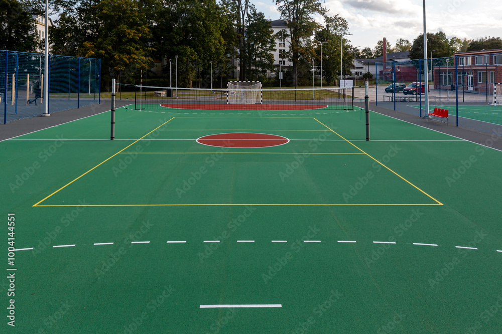 Fototapeta premium New multi-sport court opened at local park featuring basketball and tennis facilities