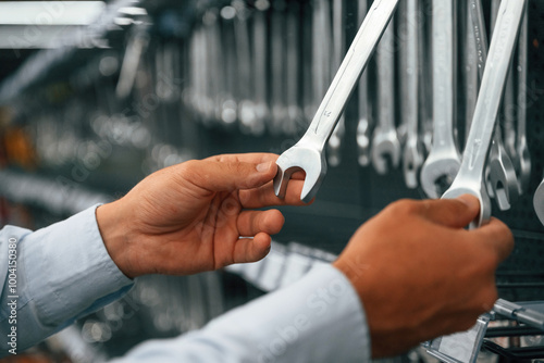 Bunch of wrenches. Man is in the hardware shop photo