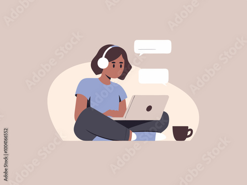 Person with headphones using laptop and coffee cup nearby