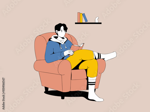Person reading a book on an armchair