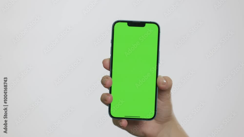 Close Up of Mobile Phone With Green Mock-up Screen In Women's Hands On White Background. Man Doing Swiping, Scrolling Gestures. Internet Social Networks Browsing News, Financial Reports Close Up of Mobile Phone With Green Mock-up Screen In Women's Hands On White Background. Man Doing Swiping, Scrolling Gestures. Internet Social Networks Browsing News, Financial Reports